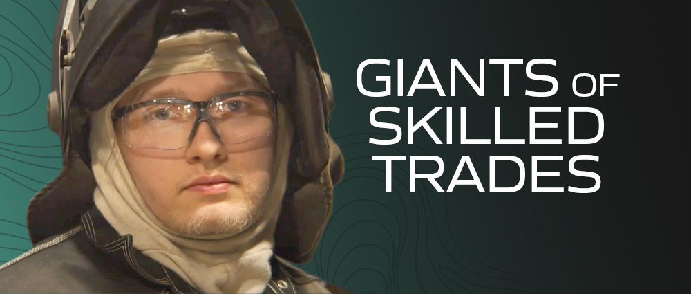 man with glasses wearing a welding hat giants of skilled trades