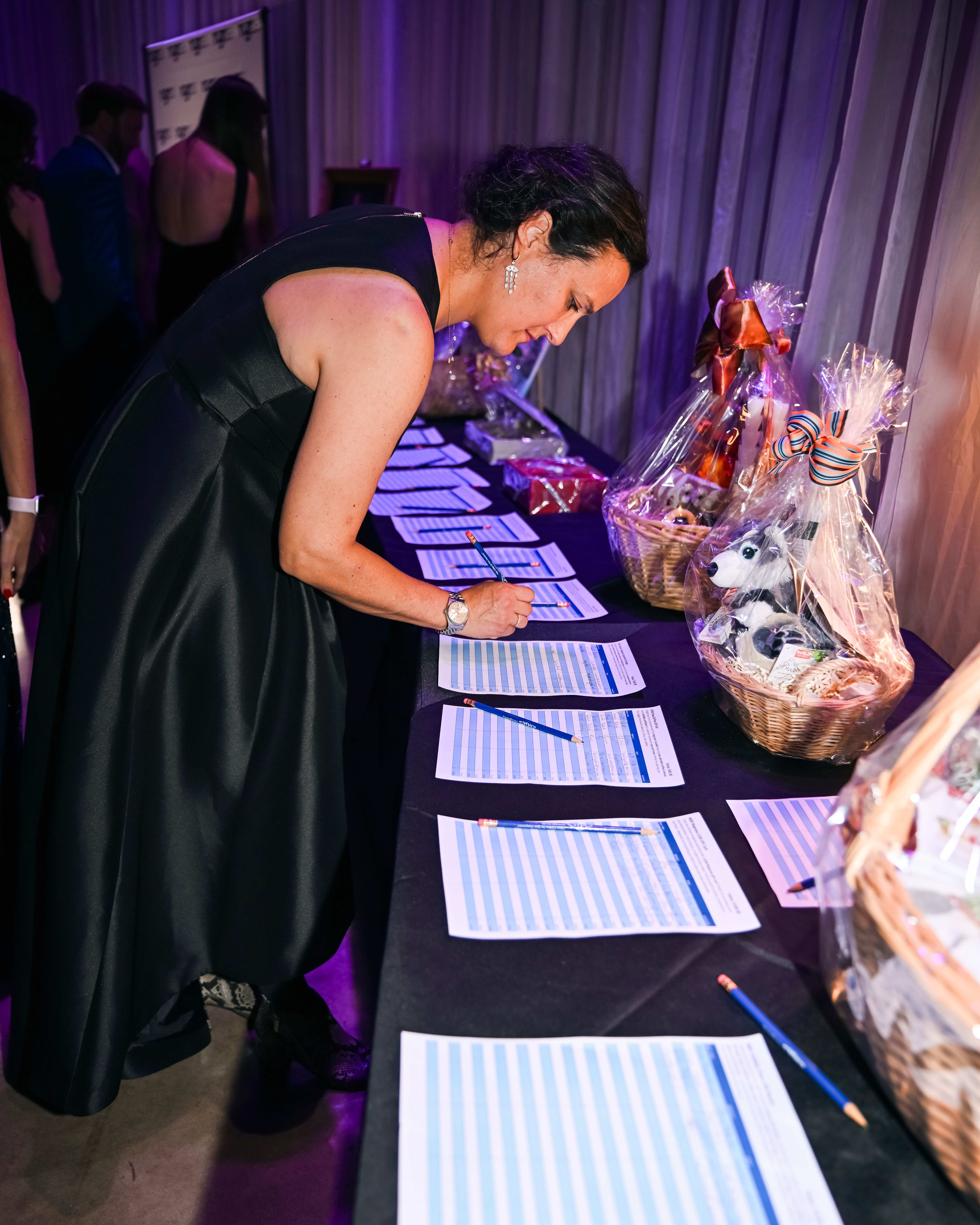 A guest placing a silent auction bid