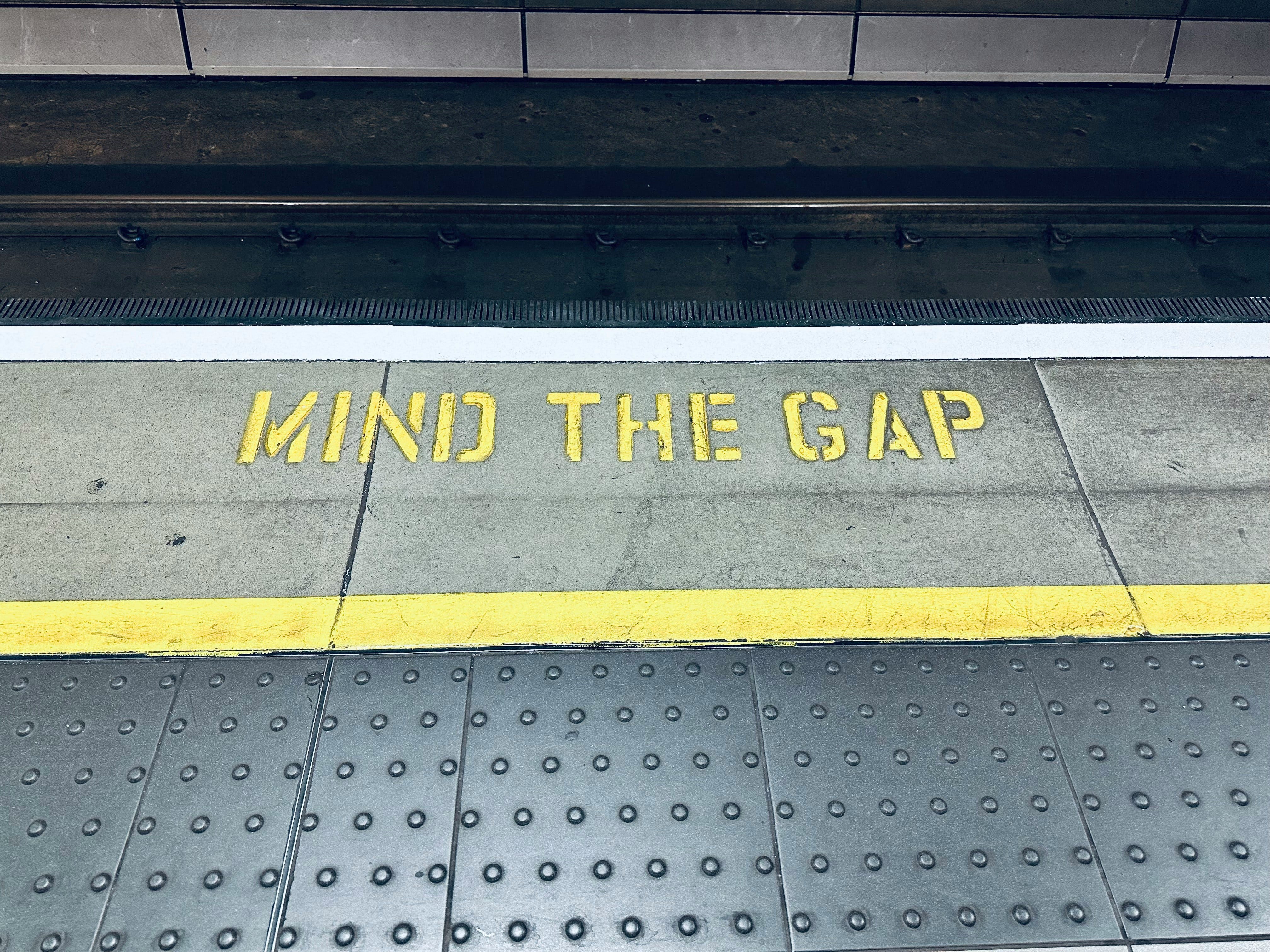 A subway platform edge with “Mind the Gap” markings representing the talent gap in the tax industry, featured in the Serac Ventures article “Fired by My Accountant: What It Taught Me About the Talent Gap in Tax.”