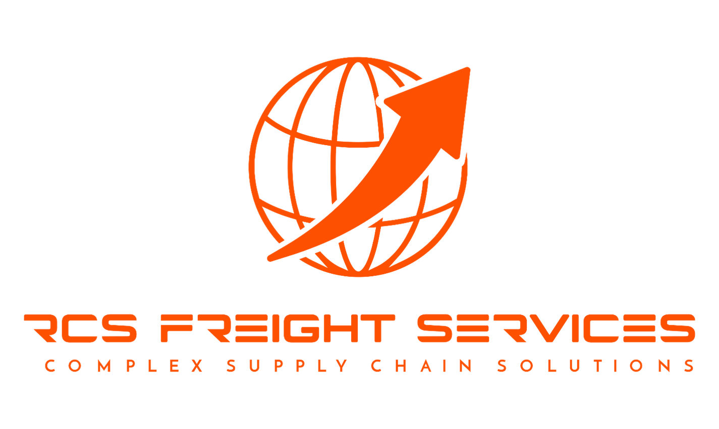 Black RCS Trucking semi-truck with chrome grille and orange logo, parked outdoors on a clear day.