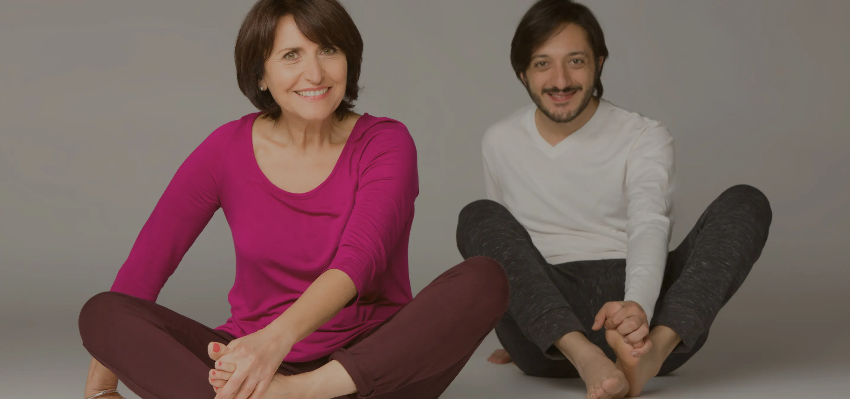 a man and a woman sitting in a cross-legged position