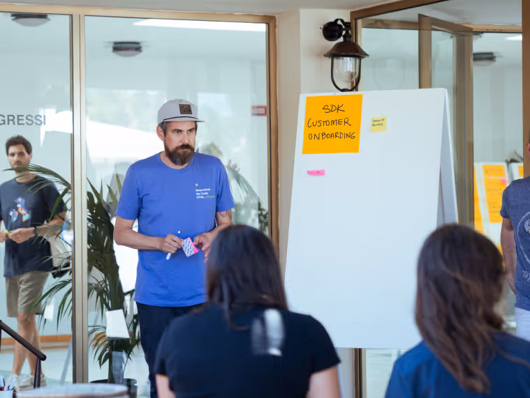 Team member leading SDK customer onboarding session with flip chart during Beefree workshop or planning event.