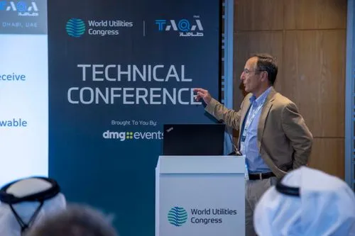 Man in a beige blazer giving a presentation at the World Utilities Congress Technical Conference podium.