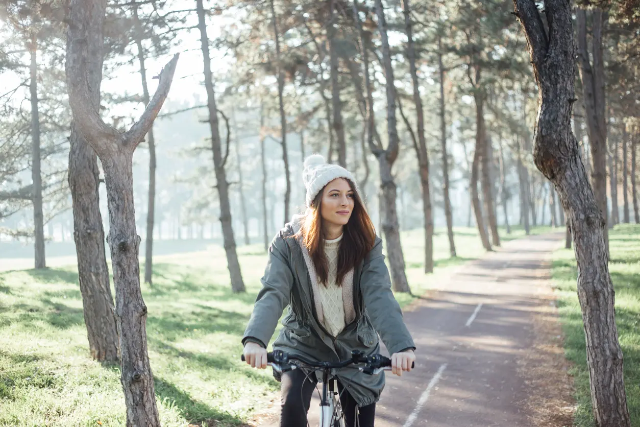 Frau fährt Fahrrad im Winter