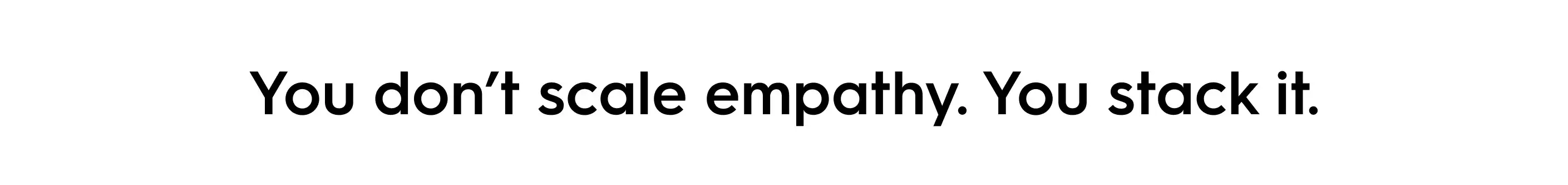 Quote text reading ‘You don’t scale empathy. You stack it.’ in bold black font on a white background — minimalist design emphasizing empathy in AI customer support.