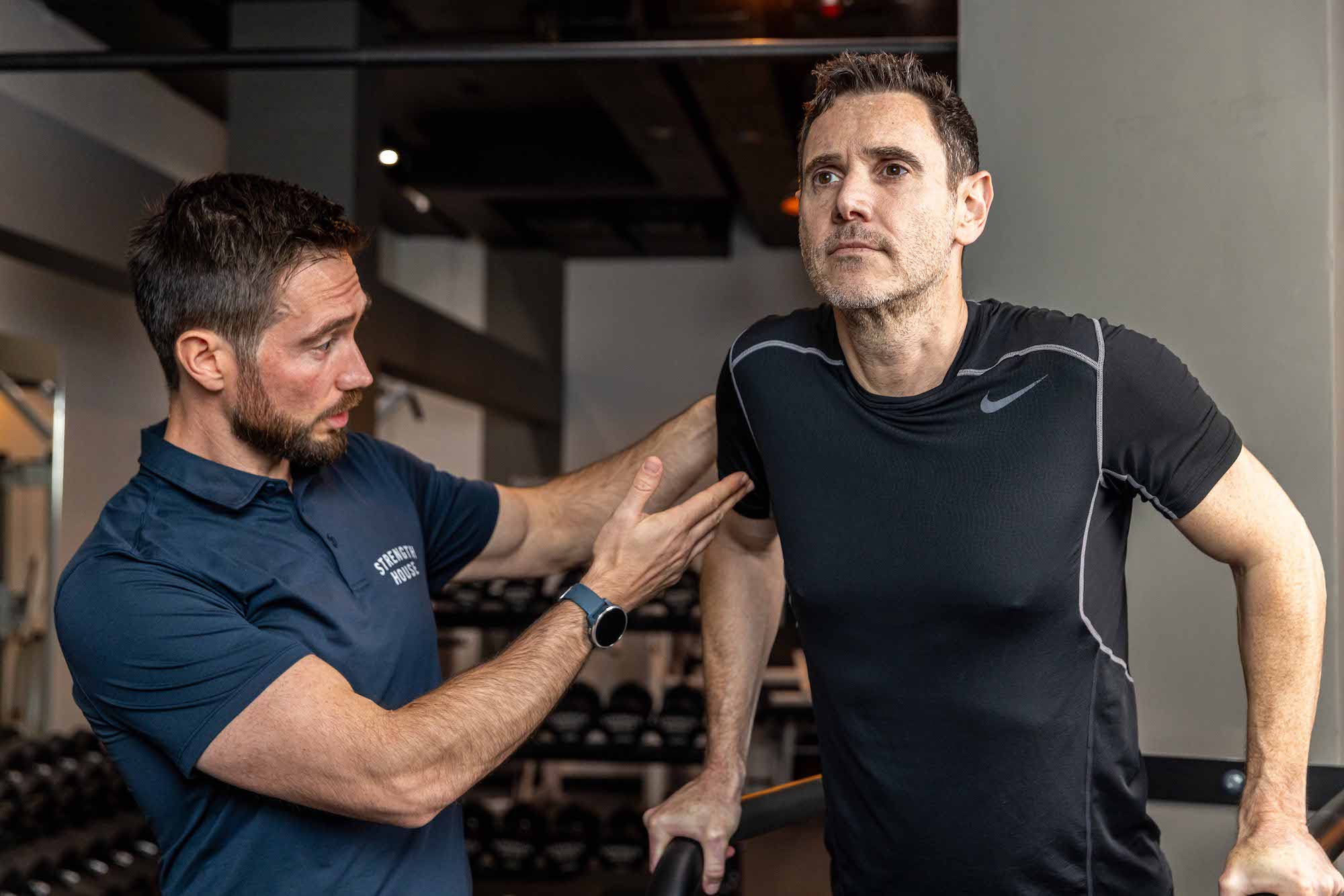 Client performing resistance exercise in guided session with trainer to improve strength and stability