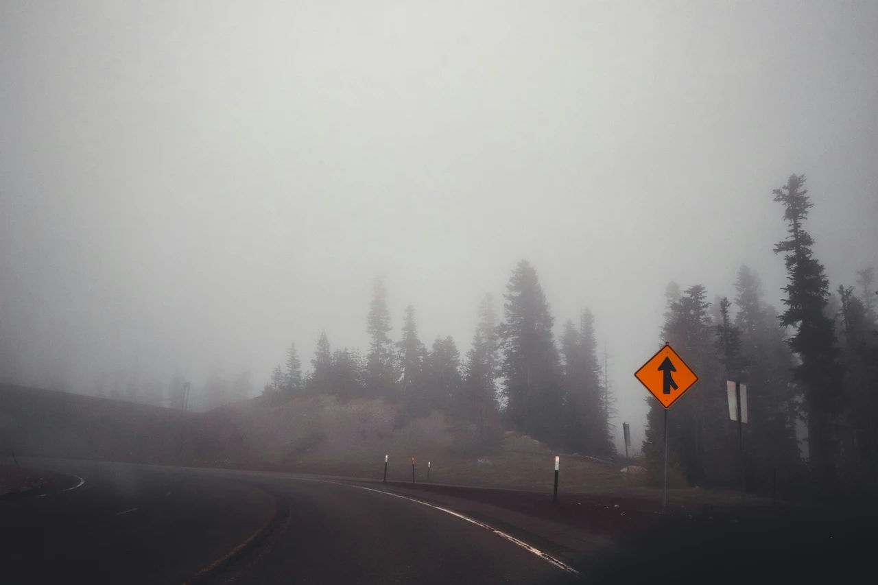 smoky highway wiht a forest in wildfire season