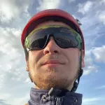 A man wearing a helmet and goggles on a sunny day.