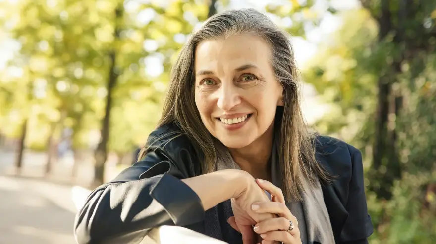 Young woman with laser corrected eyes smiling outdoors