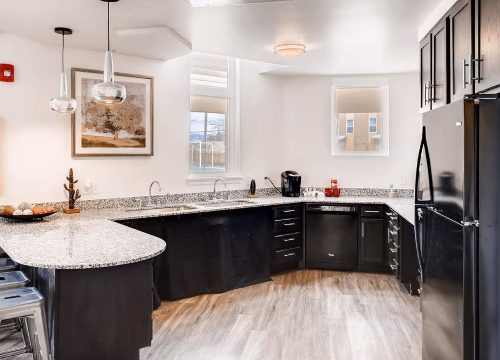 Community kitchen with black appliances