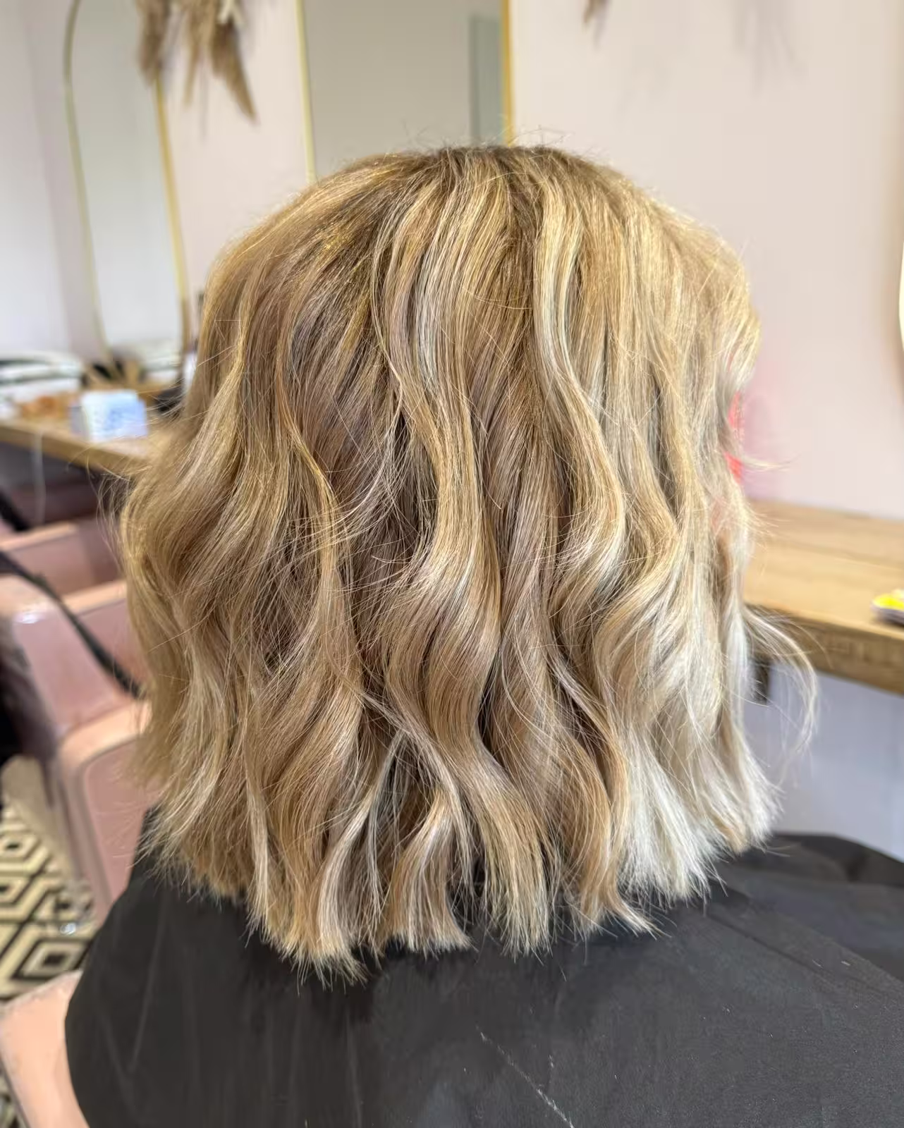 Blonde shoulder length blunt cut, style with a wave