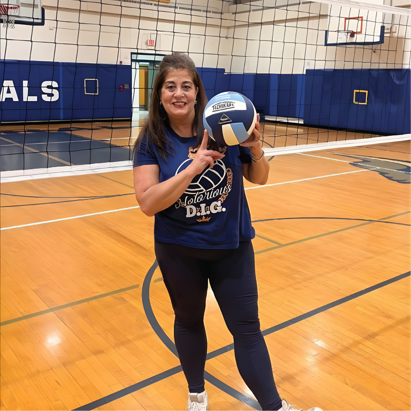 Marie Neal on court holding a vollyball