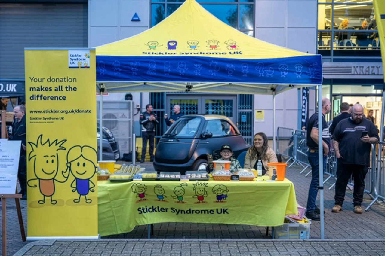A mother and son fundraising with a cake sale for Stickler Syndrome UK.