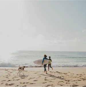 two women running towards beach