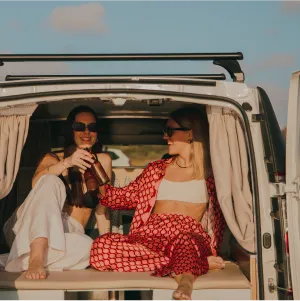 two women sitting in the van
