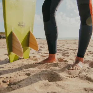 lady leg carrying surfboard