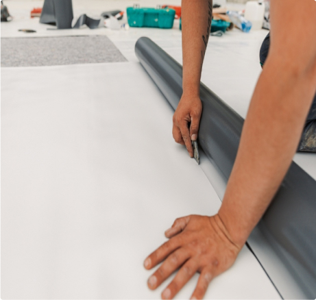 Technician installing TPO membrane on a commercial flat roof