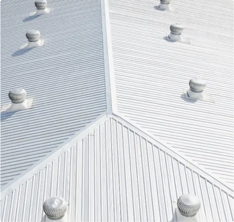 Commercial standing-seam metal roof ridge with vents