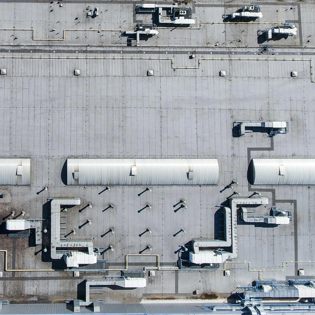 Aerial view of an industrial flat roof with equipment and ductwork
