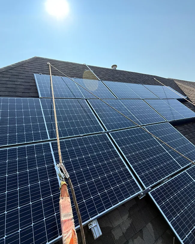 Solar panels installed on a residential roof under sunlight