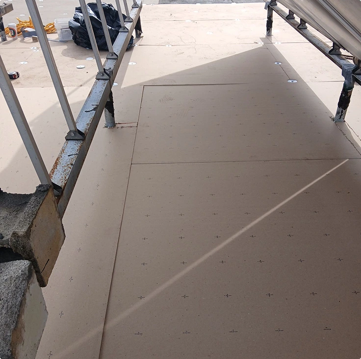 Close-up of brown flat roof deck with metal supports