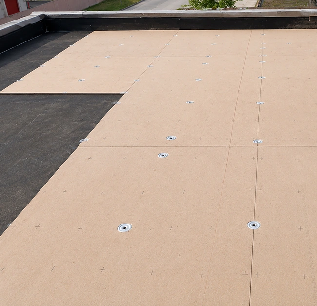 Commercial roof replacement with insulation board installed on flat roof