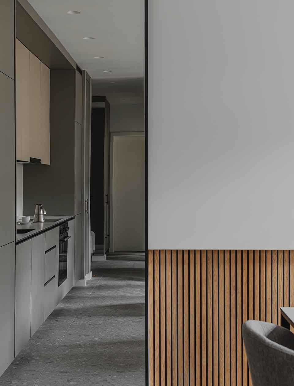 The mirror, feature wall, and kitchen connection in the micro apartments of Naumburger 34 in Leipzig