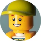 Smiling LEGO minifigure wearing a green cap.