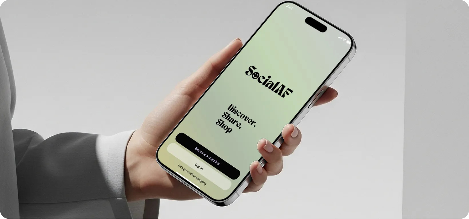 Hand holding a smartphone displaying SocialAF app with options to Become a member or Log In.