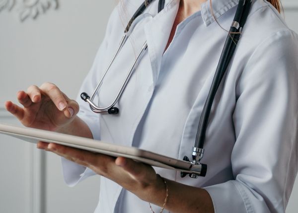 Doctor looking at a tablet.
