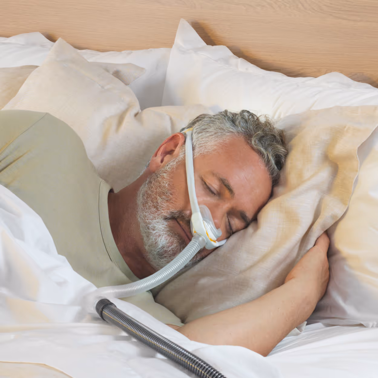 man sleeping in bed with cpap mask