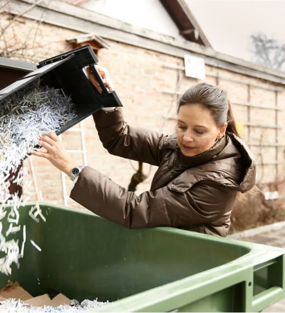 Stacked cardboard boxes on a recycling bin for commercial waste disposal services.