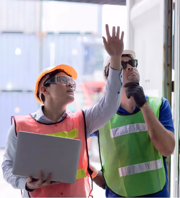 Stacked cardboard boxes on a recycling bin for commercial waste disposal services.