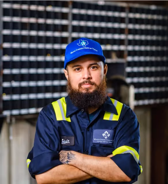 Stacked cardboard boxes on a recycling bin for commercial waste disposal services.