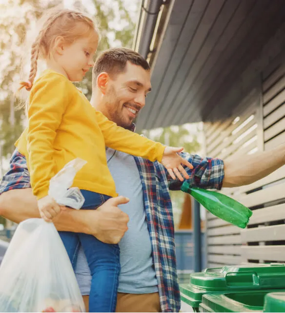 Stacked cardboard boxes on a recycling bin for commercial waste disposal services.