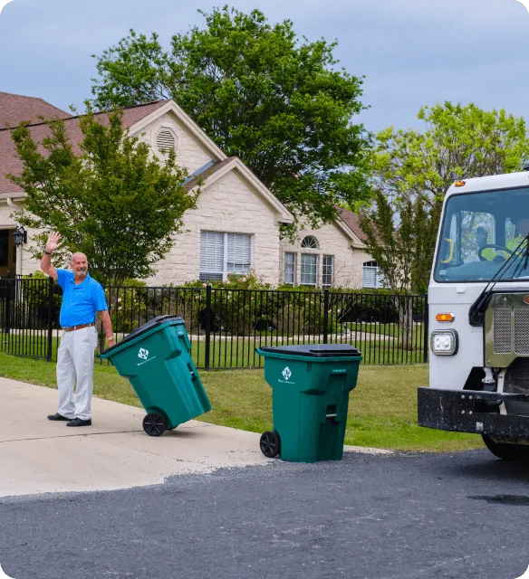 Stacked cardboard boxes on a recycling bin for commercial waste disposal services.