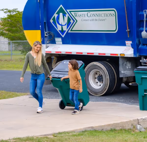 Stacked cardboard boxes on a recycling bin for commercial waste disposal services.