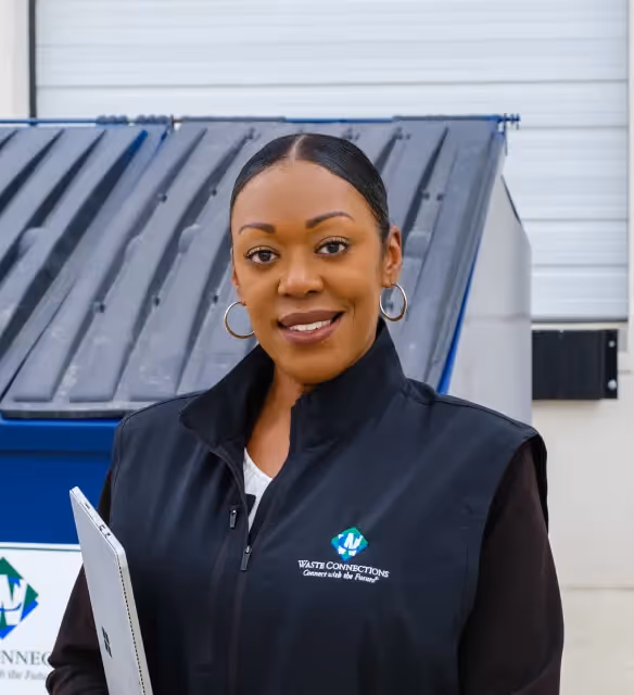 Stacked cardboard boxes on a recycling bin for commercial waste disposal services.
