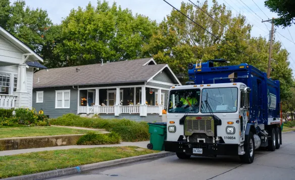 Stacked cardboard boxes on a recycling bin for commercial waste disposal services.