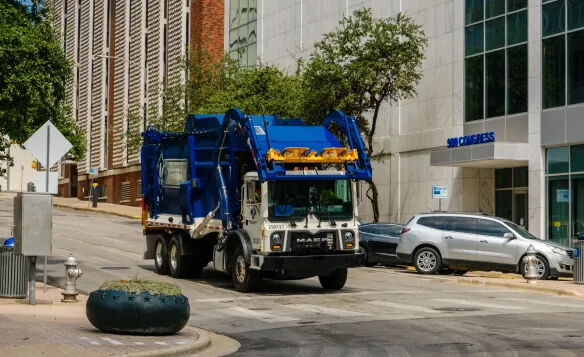 Stacked cardboard boxes on a recycling bin for commercial waste disposal services.