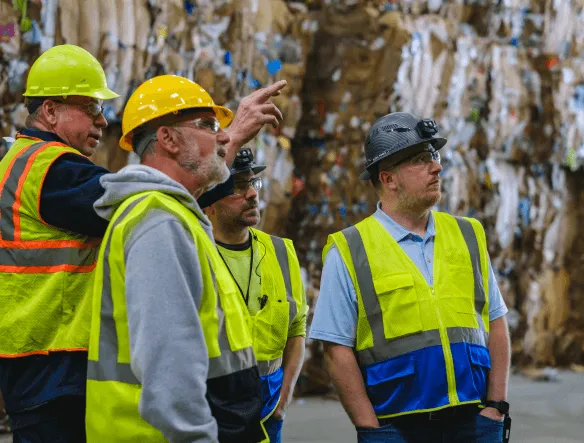 Stacked cardboard boxes on a recycling bin for commercial waste disposal services.