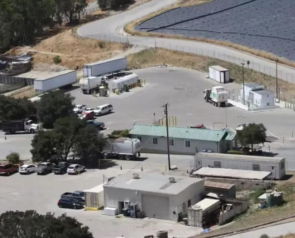 Stacked cardboard boxes on a recycling bin for commercial waste disposal services.