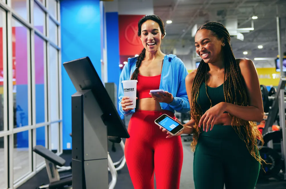 Two women entering a group fitness studio