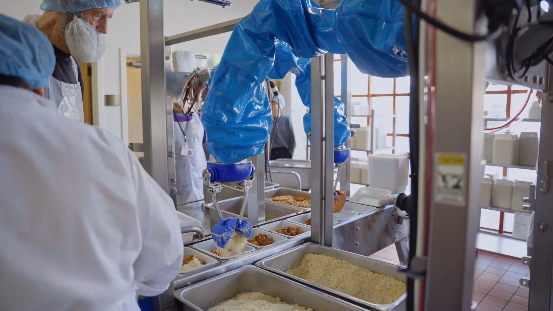 Chef robot picking and placing ingredients into compartmentalized trays