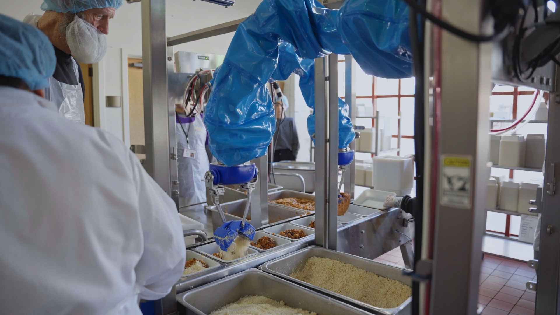 Chef robot picking and placing food into compartmentalized trays