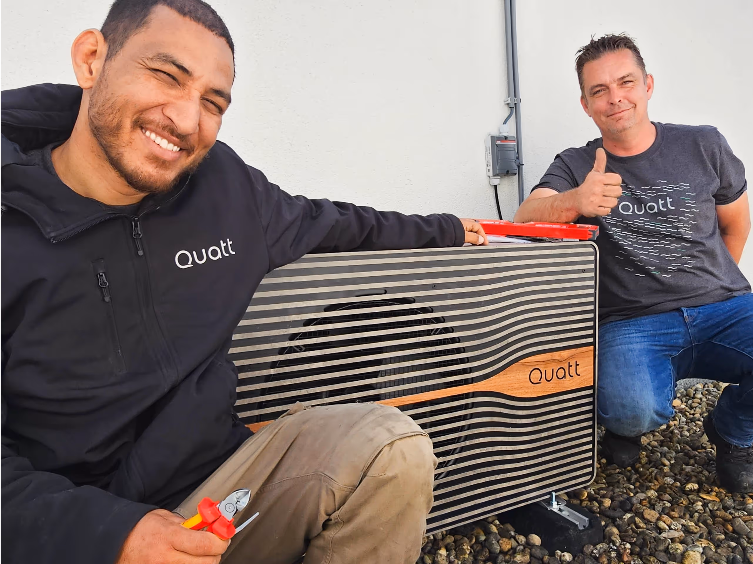 Two installers next to Quatt