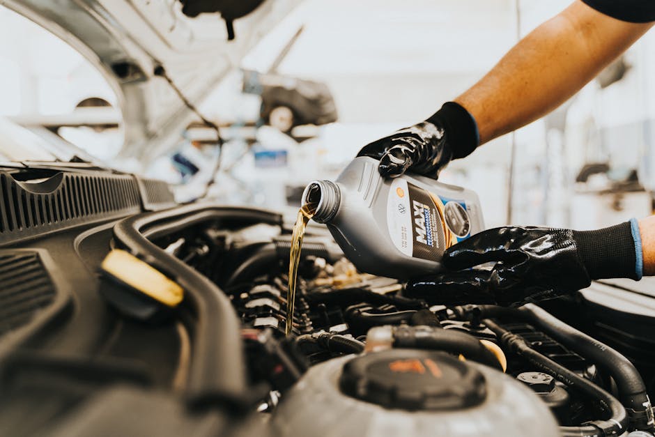 technician performing an oil change - Auto Repair Omaha