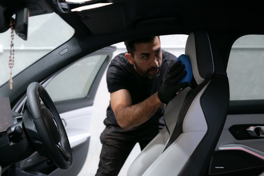 car owner checking the owner's manual for maintenance schedules - how often to change oil car owner checking the owner's manual for maintenance schedules - how often to change oil