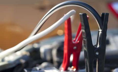 Close-up of red and black jumper cable clamps