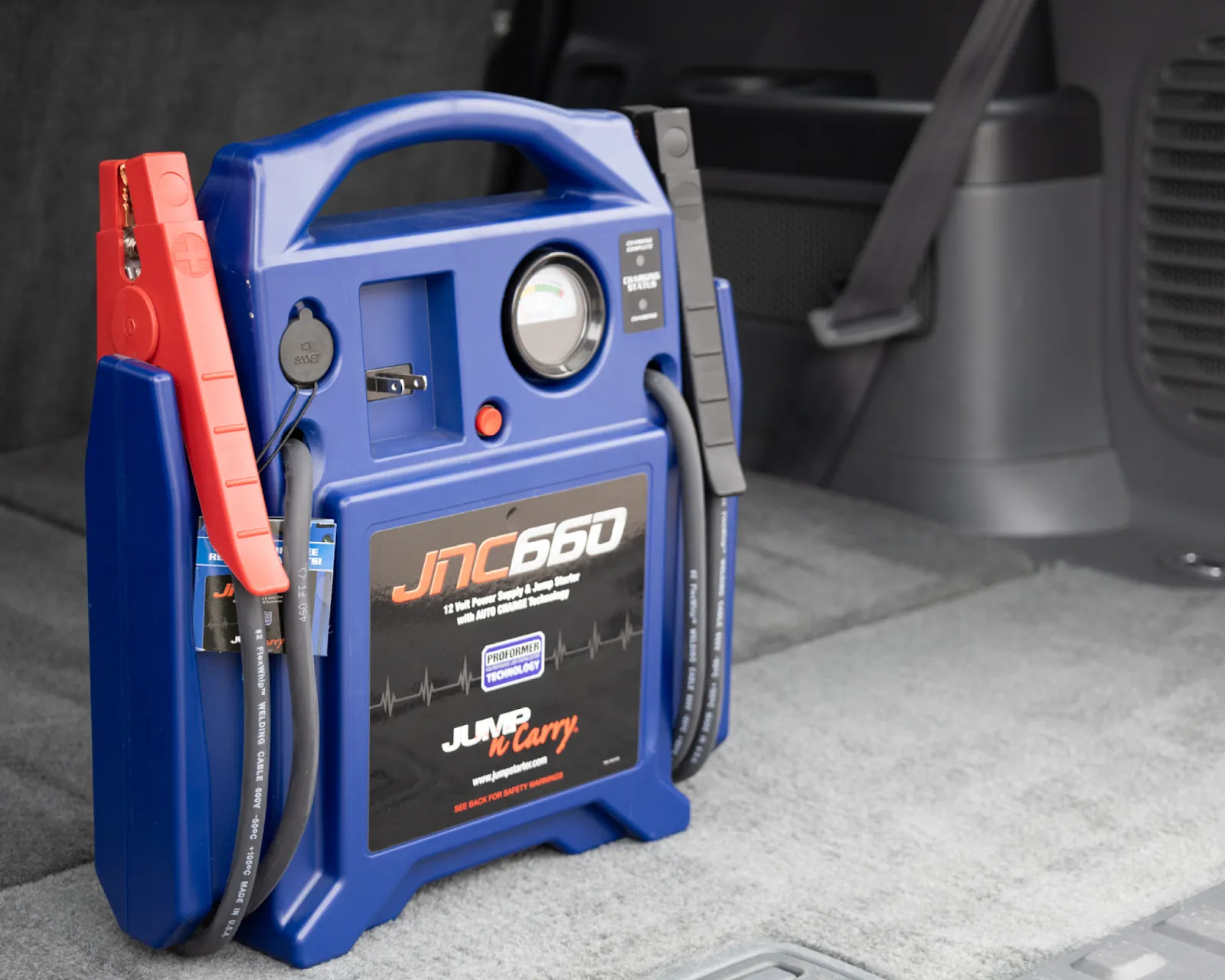 Portable jump starter in a car trunk